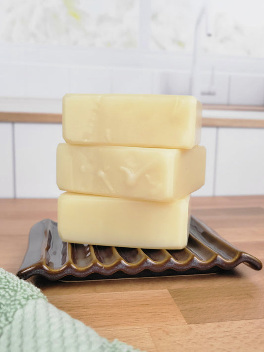Three bars of Bare Bars stacked on a soap dish