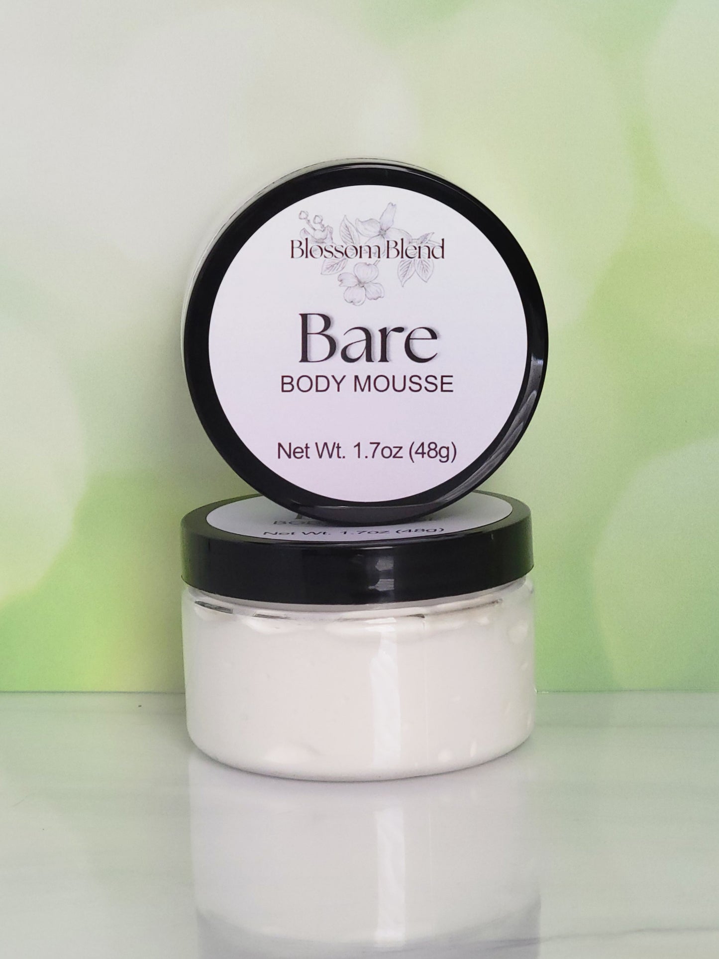 Jar of Blossom Blend Bare Body Mousse with a white background