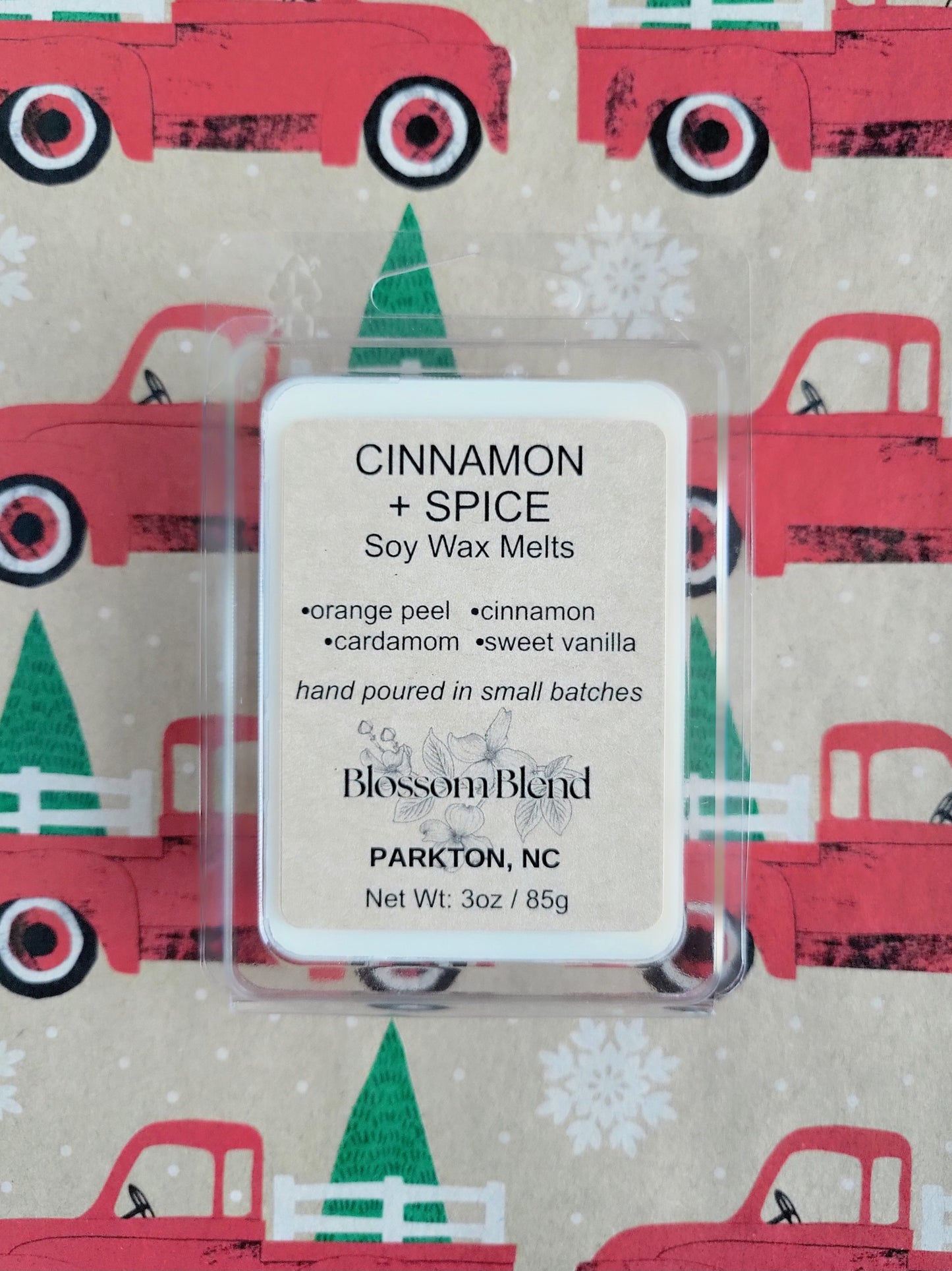 Cinnamon and Spice soy wax melts packaging with a Christmas-themed background