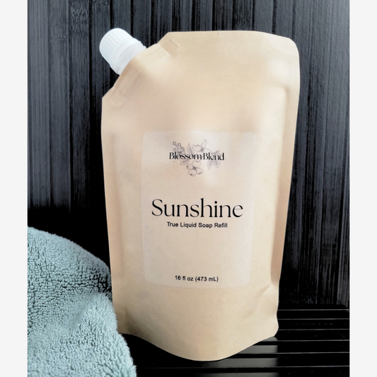 True Liquid Soap refill pouch labeled 'Sunshine' with a towel in the background