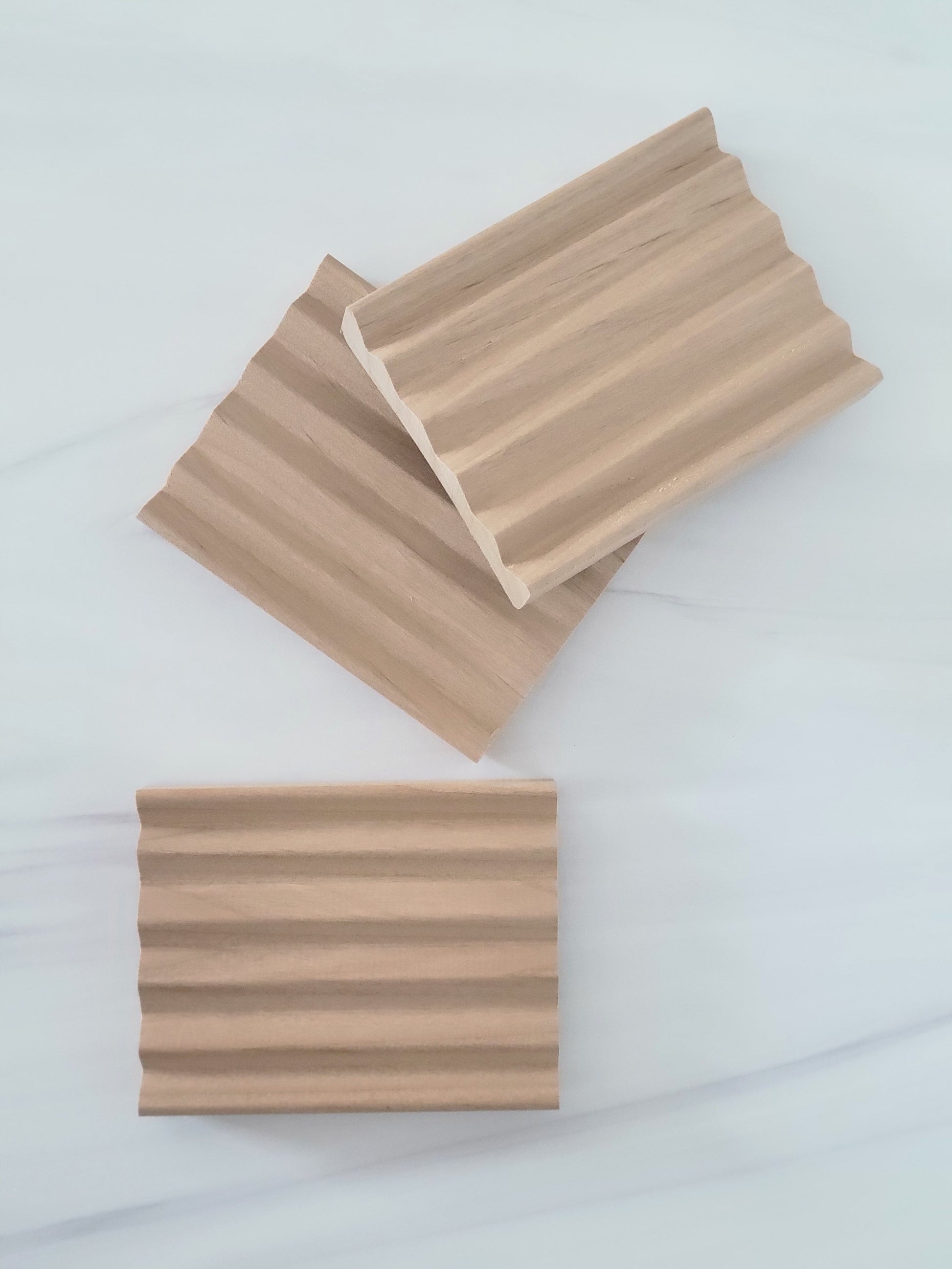 Top view of three empty poplar wood soap dishes